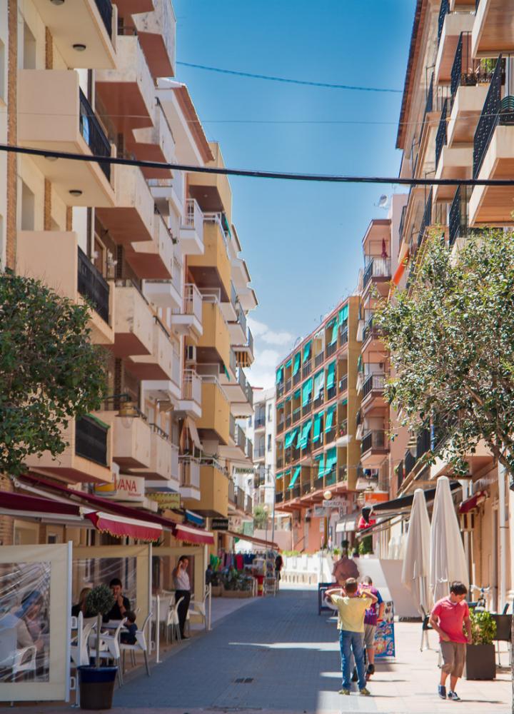 The apartment is located in this central passageway, in the 2nd building on the left.